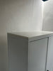 Metal double door cupboard with a white wood top